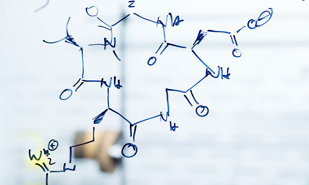 Chemistry fomulas written on a glass wall